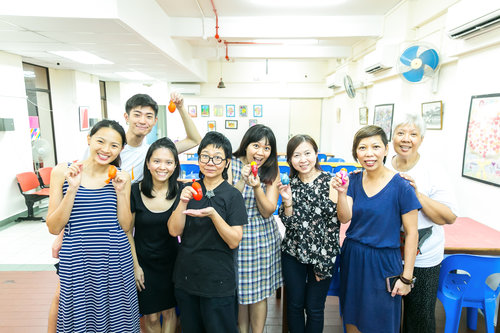 Our Drama Box crew proudly showing off their own handmade stress balls with members of the Kreta Ayer Senior Activity Centre